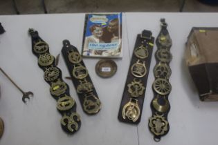 Four sets of horse brasses set to leather straps and two books The Anglers Mail Annual for 1986