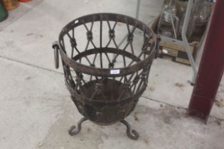 A large ornate metal twin handled log basket