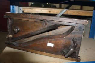 A large wooden bread slicer