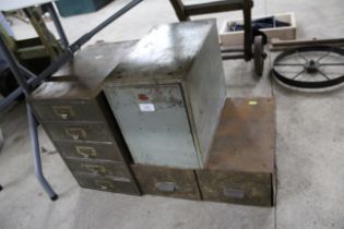 A nest of metal filing drawers, two further filing