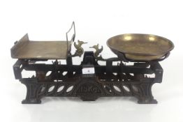 A set of vintage 15kg shop scales with brass pans