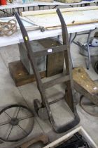 A vintage wooden and metal wheeled sack barrow