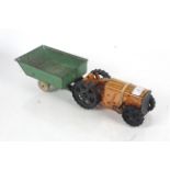 A wind-up tin model of a tractor with trailer AF
