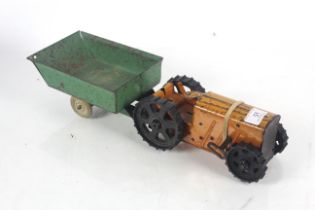 A wind-up tin model of a tractor with trailer AF