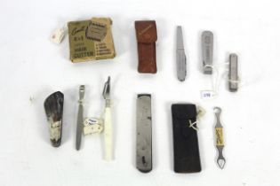 A box containing various pen knives, scraper file,