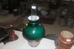 A Bialladin table oil lamp with green glass shade