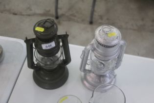 Two medium sized hurricane lamps