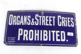 An enamel sign for "Organs and Street Cries Prohib