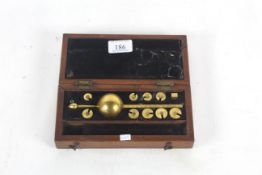 A brass hydrometer in fitted wooden case