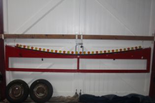 A red painted fairground facia panel with lights fitted, approx. 136½" wide