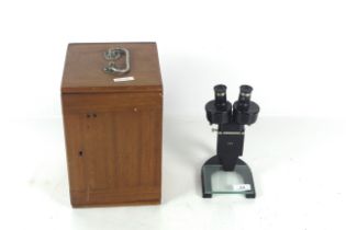 A cased binocular microscope with case and lenses