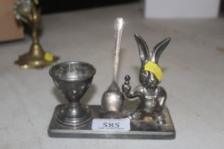 A small plated Christening set comprising spoon and egg cup depicting a rabbit