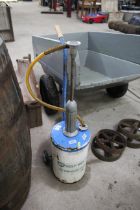 A BP Self Mix Oil dispenser for 2 stroke engines on trolley base