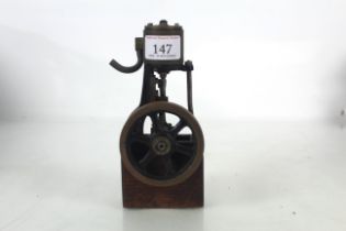 A wooden mounted cast iron and brass miniature tab