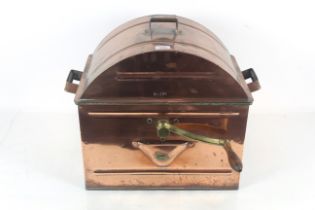 A vintage copper hand washing machine with revolvi