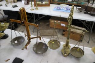 A set of brass balance scales with a set of brass