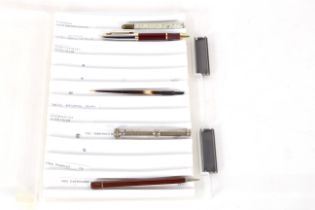A box containing five various pens
