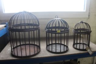 Three graduated metal bird cages