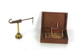 A brass travelling set of scales with wooden trave