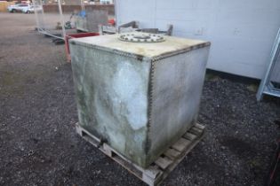 A large galvanised and riveted tank with tap and s