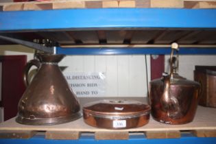 An antique copper gallon jug; a copper kettle and a copper and brass hot water bottle