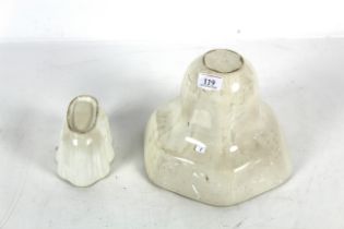 Two ceramic jelly moulds, one large and one small