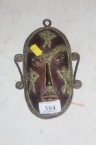 A brass painted Oriental mask