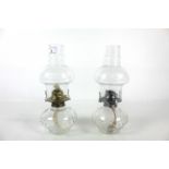 Two glass oil lamps with dimpled glass reservoirs