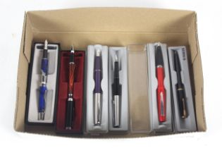 A box containing four various Parker pens and two