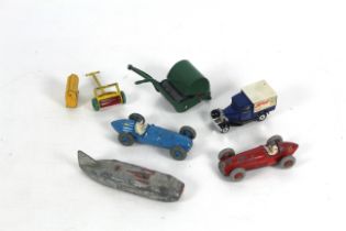 Two models of racing cars, one land speed record car and two lawnmowers