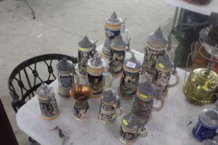 Twelve various decorative beer Steins with metal lids and one vase