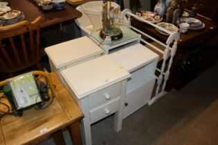 A pair of white painted bedside tables fitted two