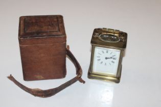 A brass cased carriage clock with travelling case