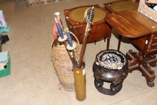 A WWI shell case and contents of swords, bayonet