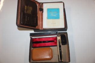 A leather writing case and box containing Parker f