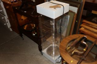 A table top revolving display case with key