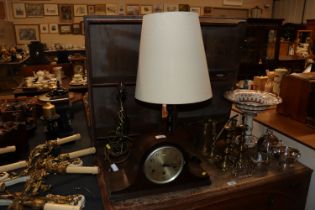 An oak cased three hole mantle clock and two brass