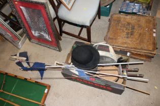 A box containing various hats; fencing foils; flag