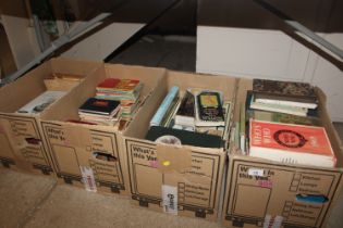 Four boxes of various books relating to antiques, railway guides, a run of Dickens and various