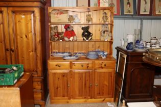 A pine dresser fitted three drawers, raised on cup