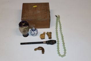 A box containing snuff bottle; jade beads;  two umbrella handles etc
