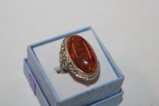 A large vintage sterling silver and amber dress ri