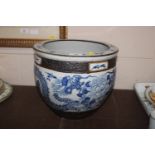 An Oriental blue and white jardiniere decorated wi