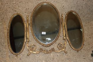 A gilt framed triptych mirror