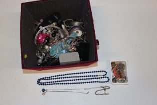 A box containing a large quantity of costume jewel