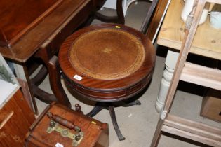 A mahogany and leather inset drum table