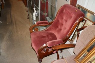 A Victorian upholstered scroll armchair