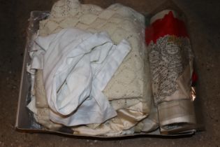 A box containing various vintage clothing etc