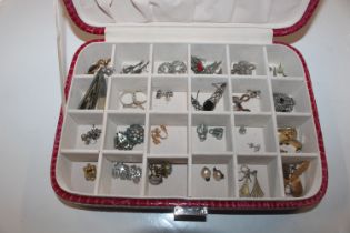 A jewellery box containing various pairs of ear-ri