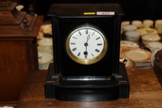 A Victorian single hold mantle clock contained in